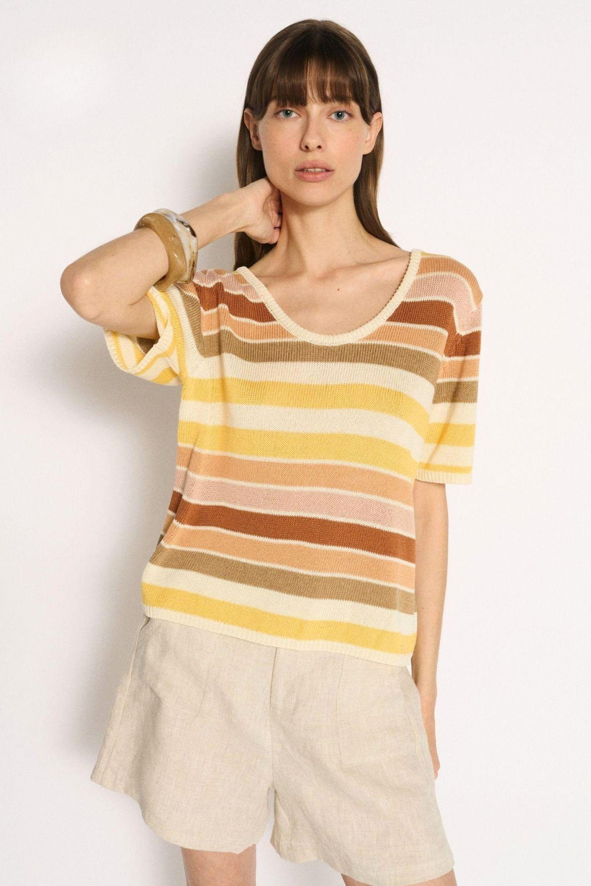 Little Lies Stevie Stripe Tee in yellow, peach and brown stripes worn with linen shorts, front view