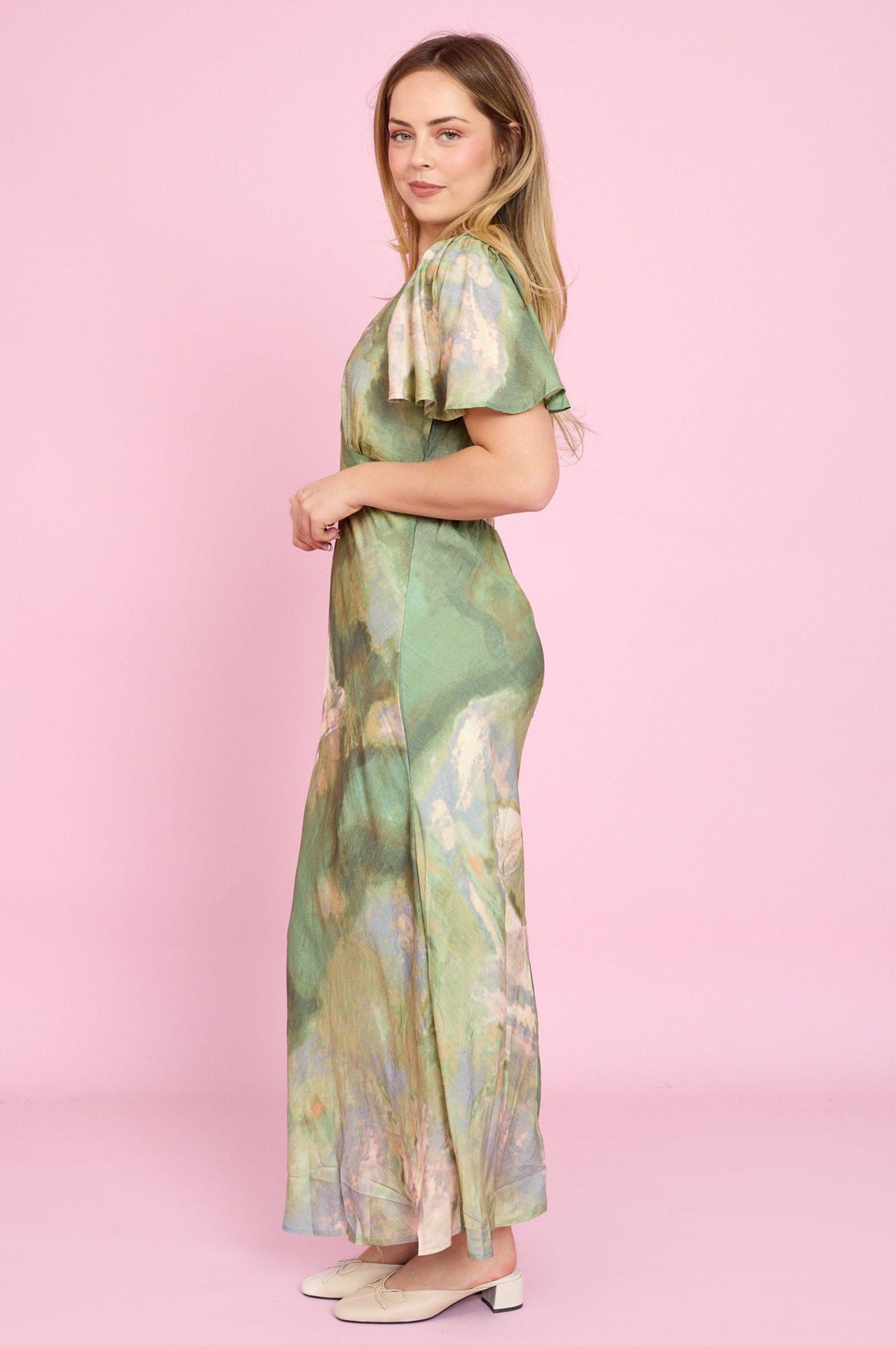 Fria The Label Dune Print Midi Dress in Sage side view of the flowing silhouette with cream flats
