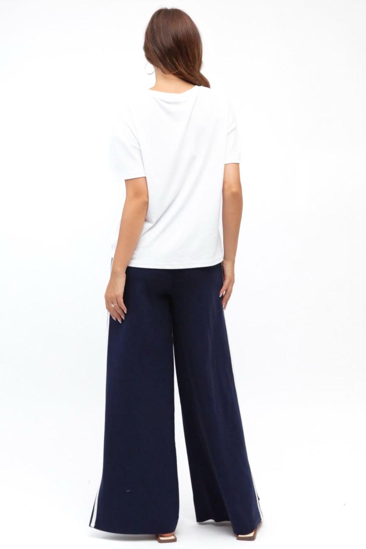 Label of Love Simba Knit Pant in Navy full-length back view with a white tee tucked in