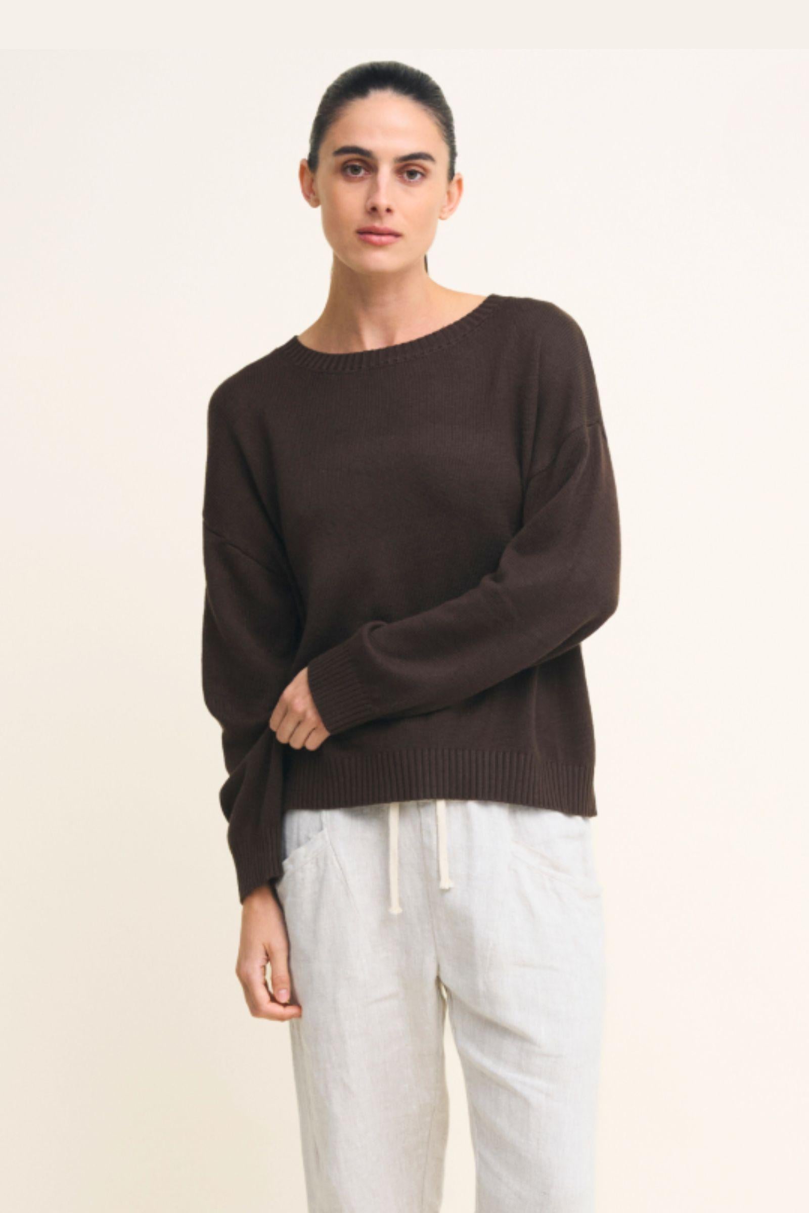 Victoria Jumper in Chocolate by Little Lies — cropped front view of chocolate brown relaxed knit jumper with boat neckline and long sleeves, styled with white drawstring linen pants, available in Australia at Kat and Ko Clothing