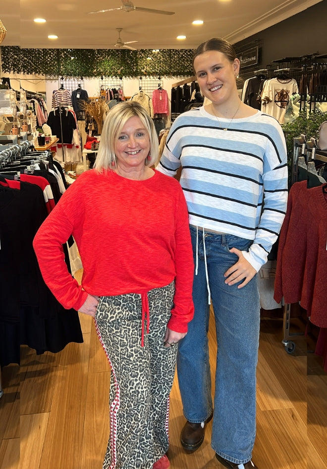 Hailey Drawstring Top by Little Lies — blue stripe and red colourways styled in Kat and Ko Clothing boutique, blue stripe worn with wide-leg jeans, red worn with leopard print pants, available in Sutherland Shire, Australia