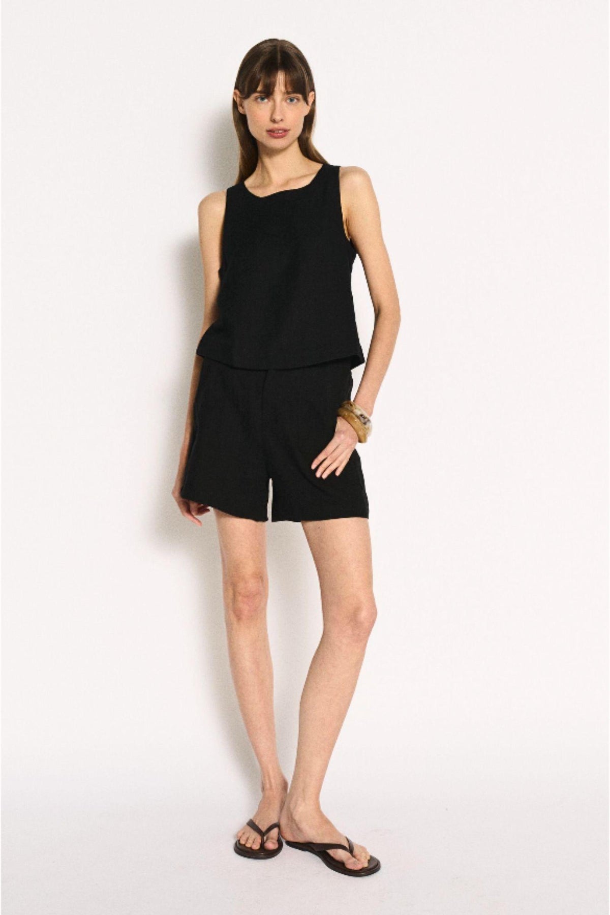 Little Lies Jude Shorts in Black full-length view styled with a matching black top and sandals