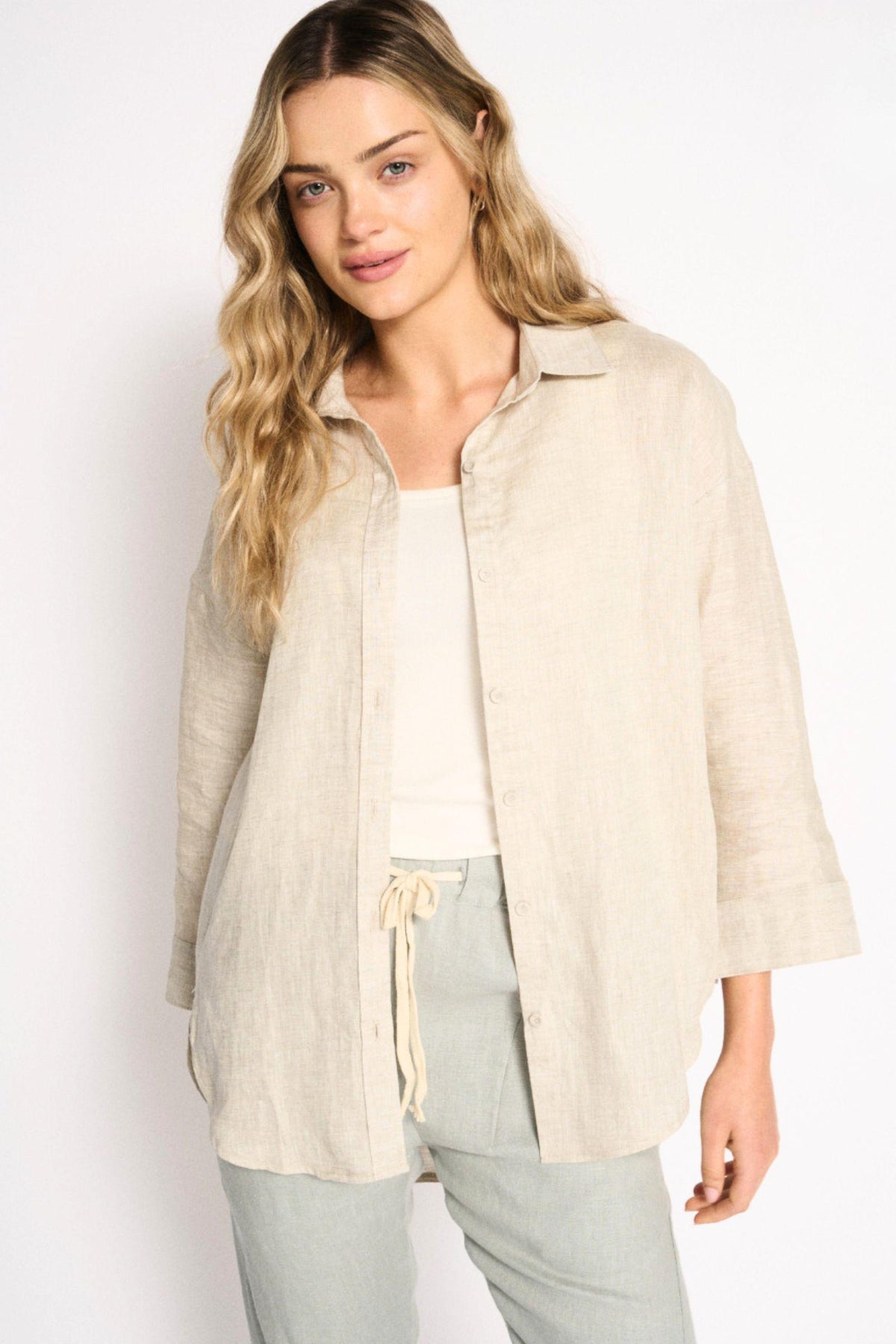Little Lies Boyfriend Shirt in Natural worn open with a white tank and grey drawstring pants