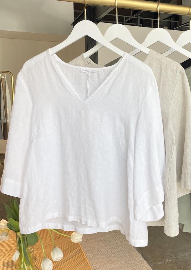 White blouse on a hanger with a blurred background
