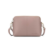 A small mushroom-colored crossbody bag with two straps, a zip closure, and a brushed gold hardware detail.