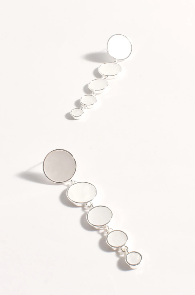 Silver earrings with circular designs on a white background