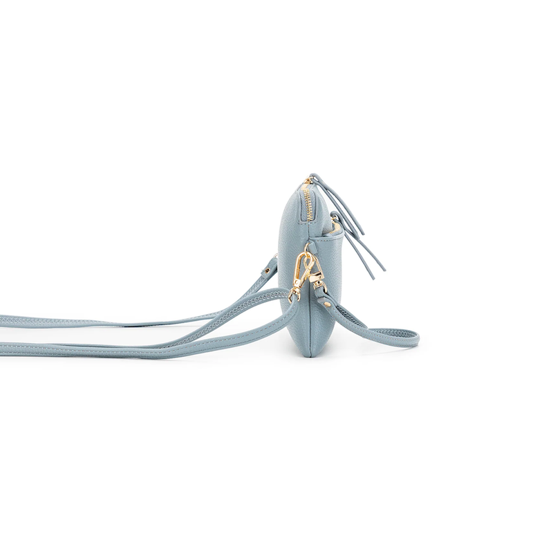 Light blue crossbody bag with gold accents on a white background