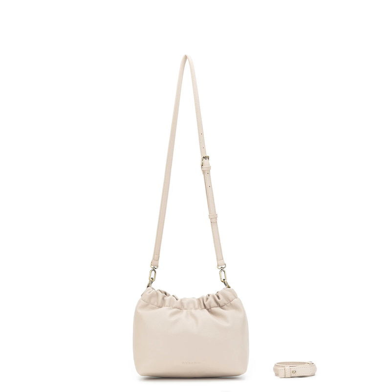 Beige shoulder bag with a matching pouch on a white background