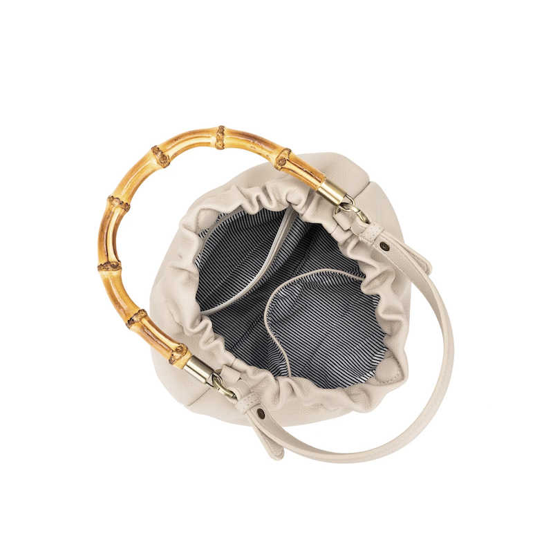 White earbud case with gold bamboo design on a white background