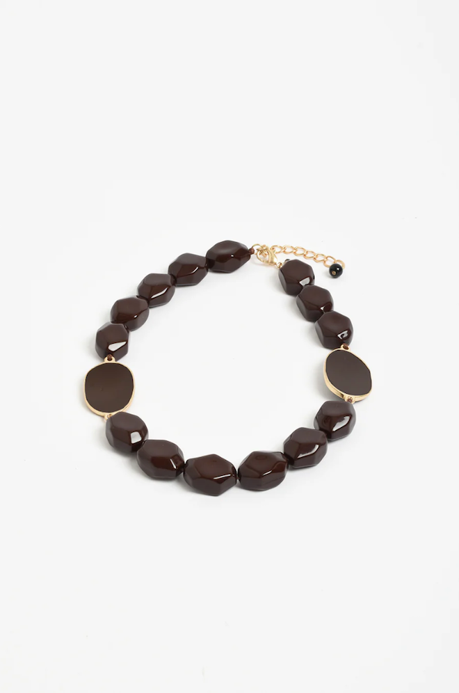 Brown beaded necklace with gold clasp on a white background