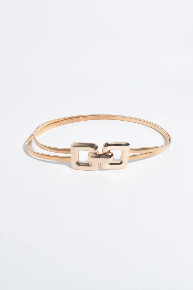 Gold bracelet with a clasp design on a white background