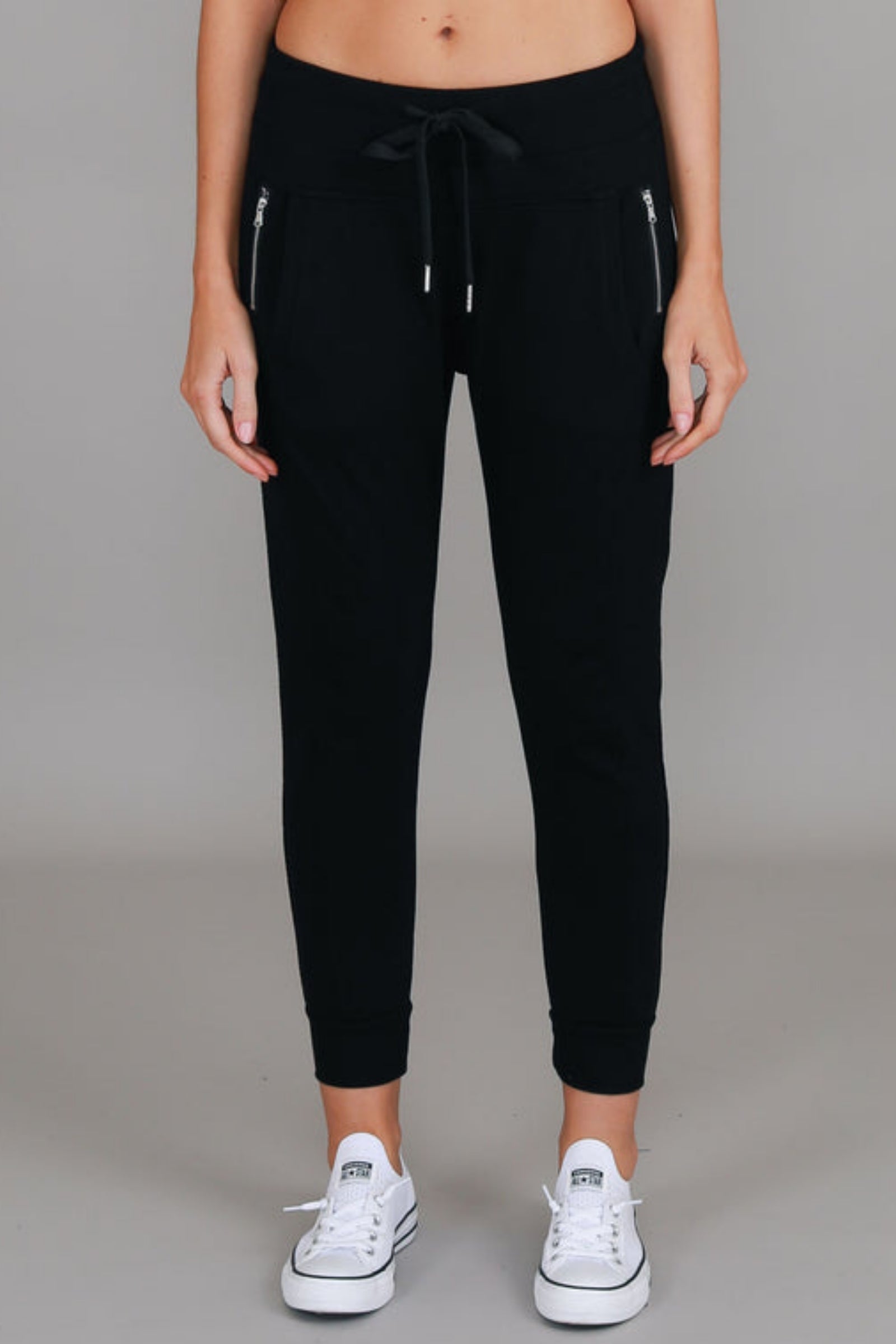 3rd Story The Label Byron Jogger Black — full-length front view of black cotton French Terry jogger with drawstring waist and silver zip pockets, styled with white sneakers, shop in Australia at Kat and Ko Clothing