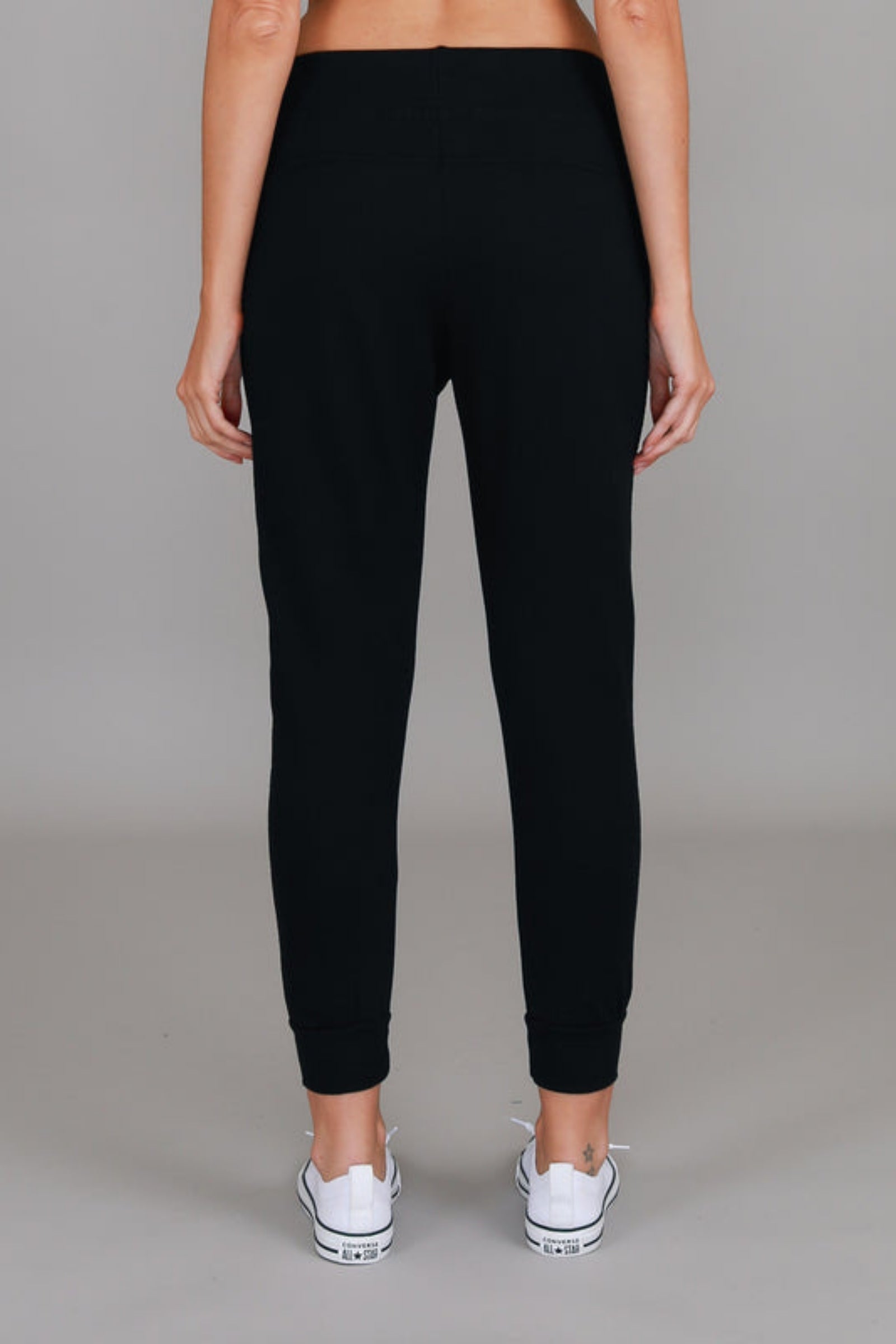 Byron Jogger Black 3rd Story The Label — back view of black cotton French Terry jogger with ribbed waistband and tapered ribbed ankle cuffs, styled with white sneakers, available in Australia at Kat and Ko Clothing