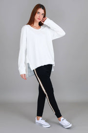 Ulverstone Sweater - White styled with black joggers, side angle