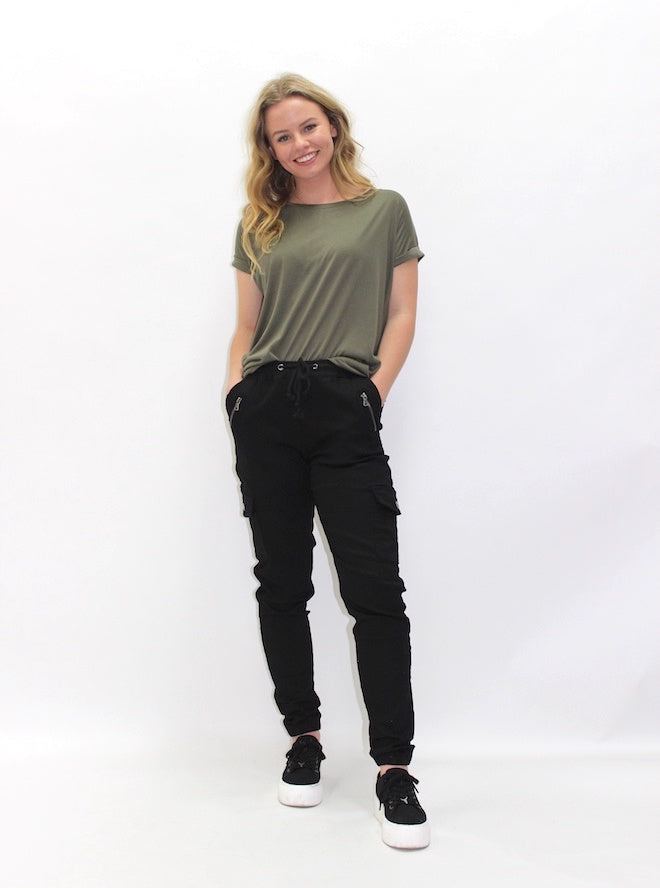 Chino Cargo Pants by Wakee Jeans — front view of model wearing black cargo pants with an olive green tee and black sneakers, shop in Australia at Kat and Ko Clothing