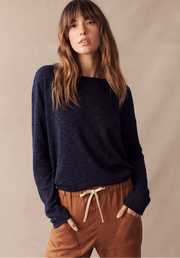 Nellie Top in Navy by Little Lies — cropped front view of navy long sleeve relaxed knit top with boat neckline, styled with tan drawstring pants, available in Australia at Kat and Ko Clothing
