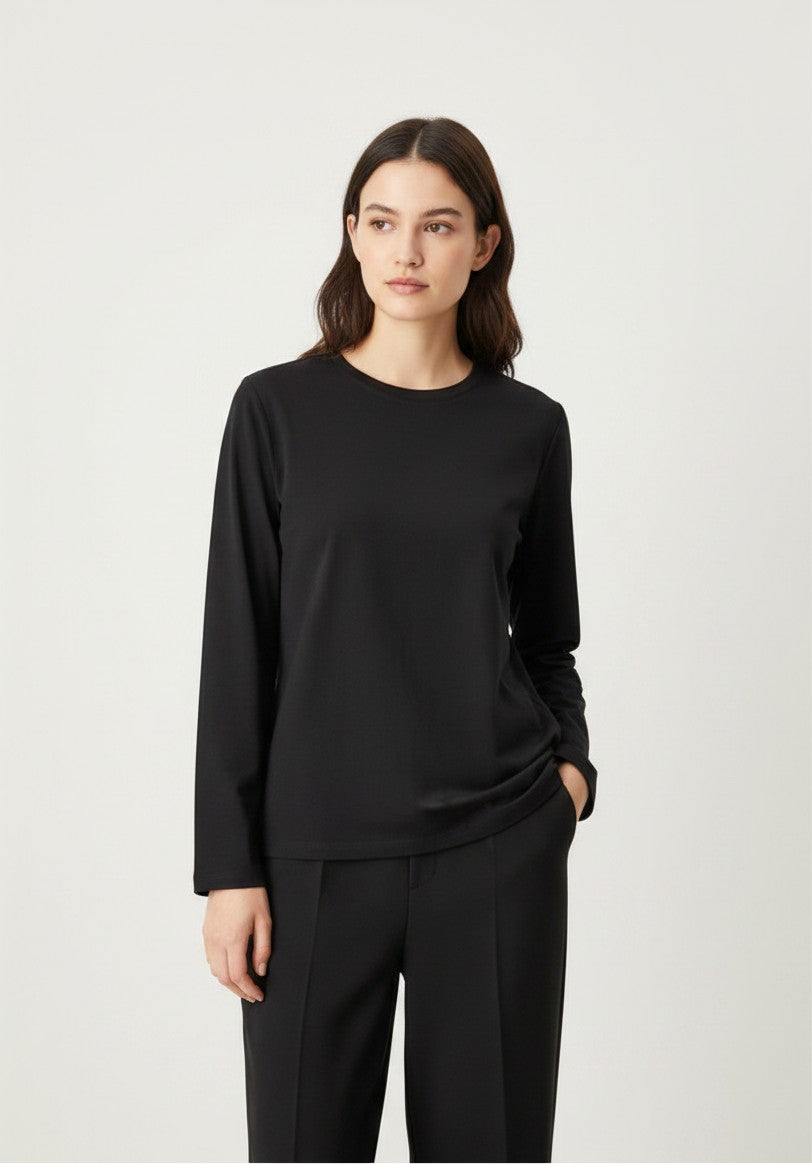 Model wearing a Kat and Ko Clothing Athena black long-sleeve basic crew neck top with a relaxed fit.