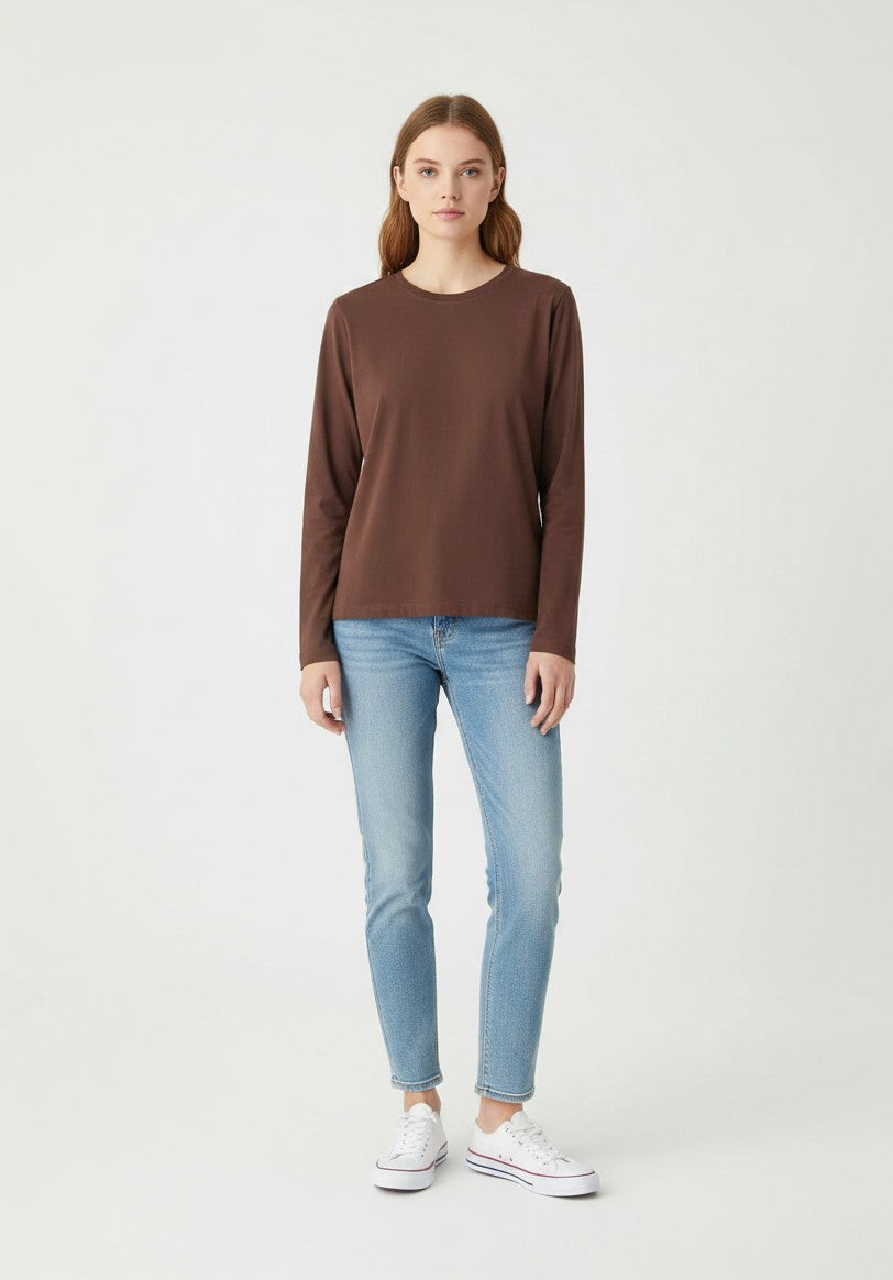 Model wearing a Kat and Ko Clothing Athena long sleeve basic top in chocolate brown with light wash blue jeans