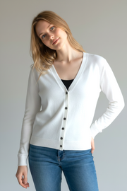 Model wearing a white Kat and Ko Clothing Caroline Cardi button-up cardigan with a V-neck and long sleeves.