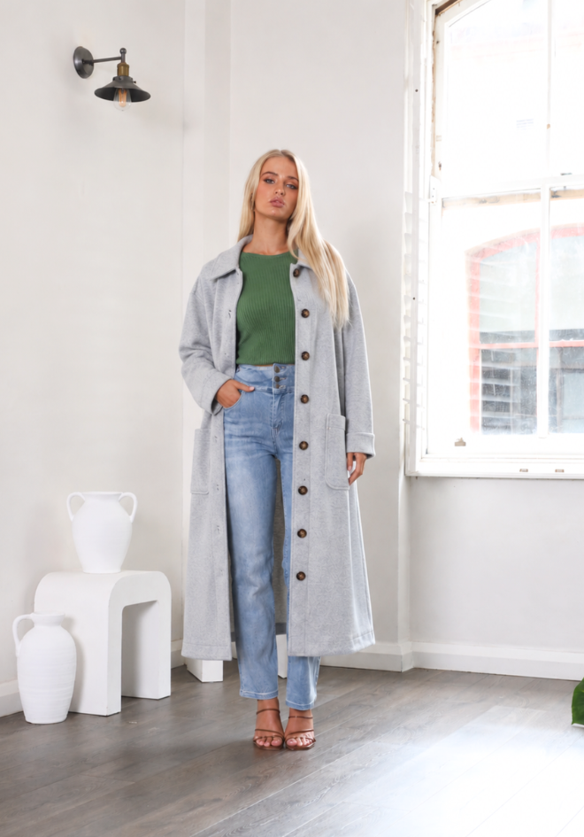 Lexie Coat Baby Blue by Refuge — full-length view of pale blue wool blend longline coat with tortoiseshell buttons, styled with green top and denim jeans, available in Australia at Kat and Ko Clothing