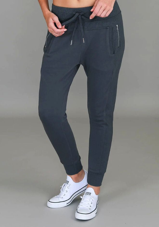 3rd Story The Label Byron Jogger Charcoal — close-up front view of charcoal slim-fit jogger pants with elasticated drawstring waist and silver zip pockets, styled with white sneakers, available in Australia at Kat and Ko Clothing