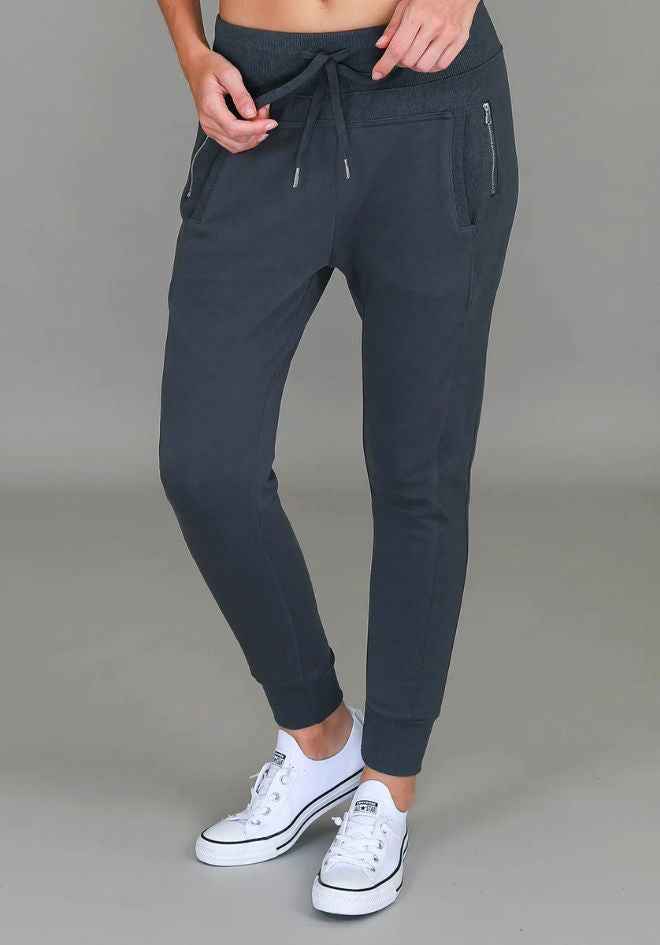 Byron Jogger in Charcoal by 3rd Story The Label — cropped front view of charcoal cotton French Terry jogger with drawstring waist, zip pockets and contrast ribbed side panels, styled with white sneakers, available in Australia at Kat and Ko Clothing
