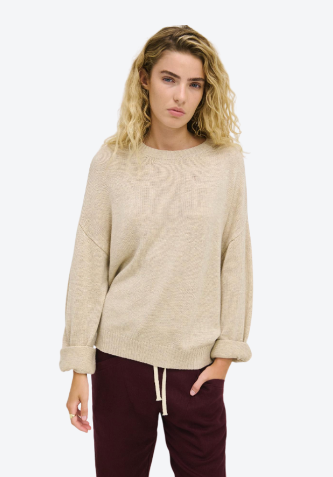 Little Lies Victoria Jumper Natural — front view hand in pocket of soft relaxed fit knit jumper with ribbed detail in versatile natural colourway