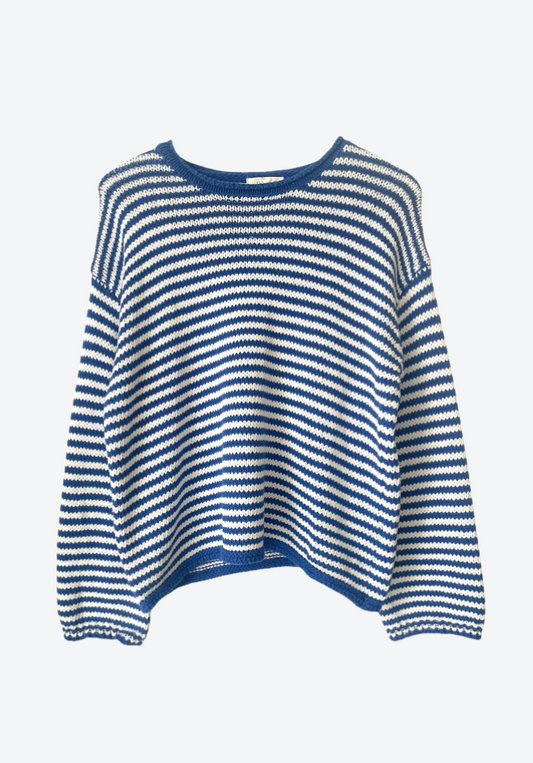 Blue and white striped sweater on a light blue background