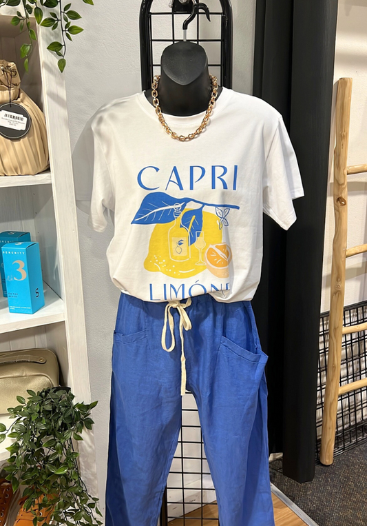 Mannequin wearing a white 'Capri Limone' t-shirt and blue pants in a store setting.