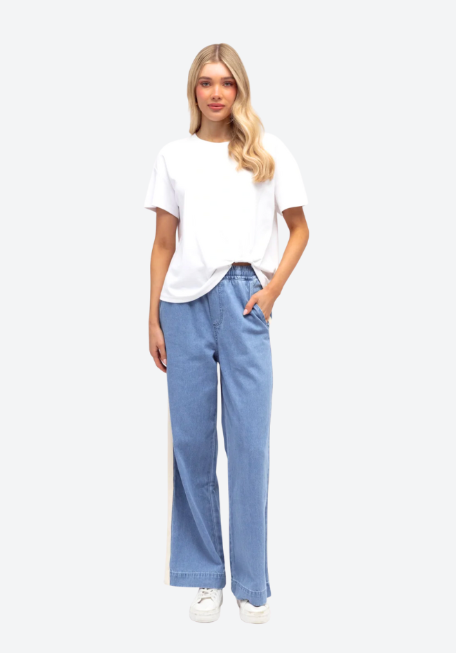 Woman wearing a white t-shirt and light blue jeans on a white background
