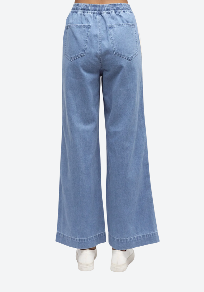 Light blue denim pants on a white background
