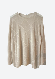 Beige sweater with a textured pattern on a white background