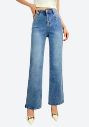 Blue jeans worn by a person on a white background