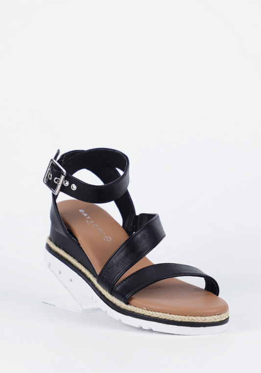 Black wedge sandal with a strap on a white background