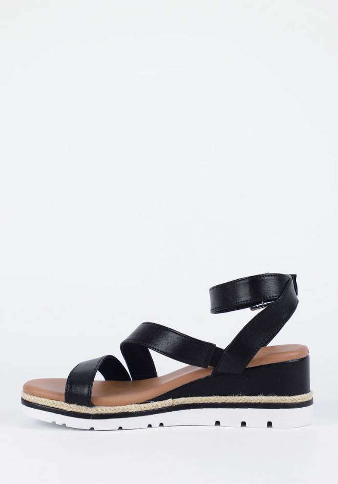 Black sandal with a platform sole on a white background