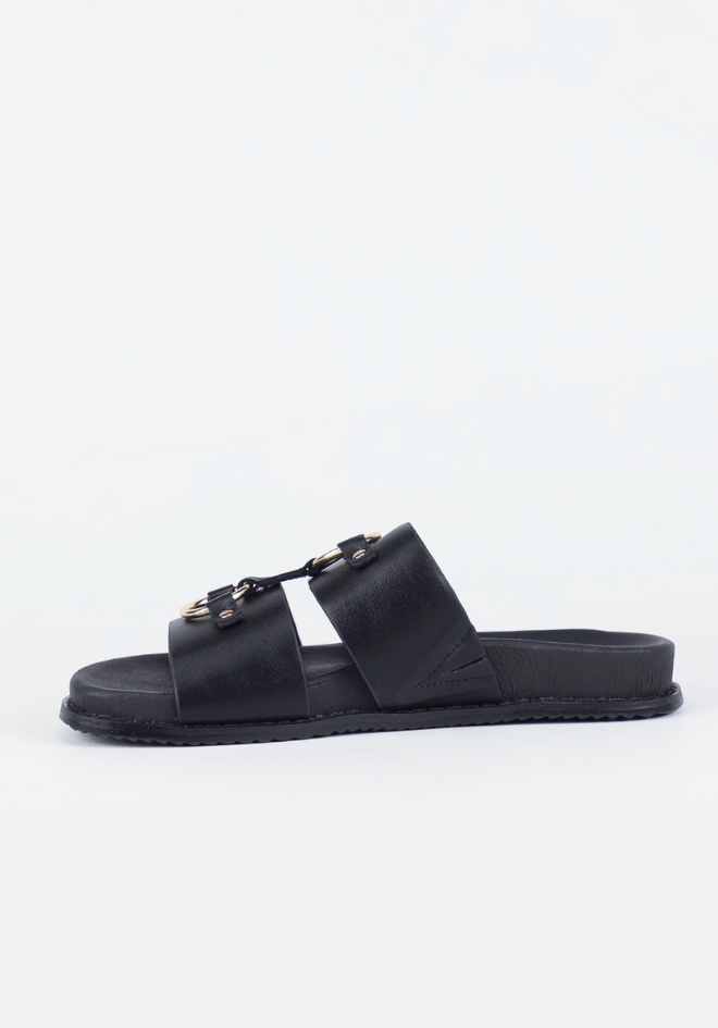 Black slide sandal with gold accents on a white background