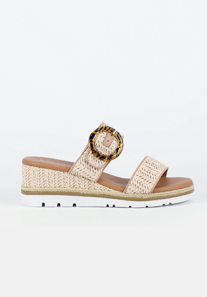 Beige wedge sandal with woven design on a white background