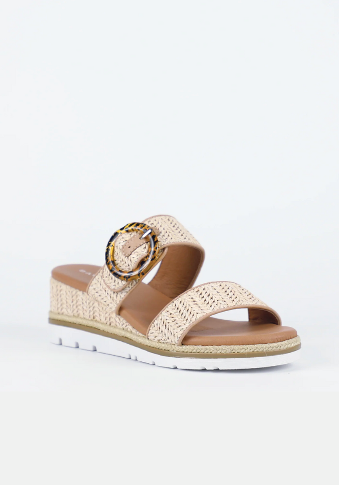 Beige sandal with woven design and decorative buckle on a white background