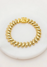 Gold bracelet on a white background