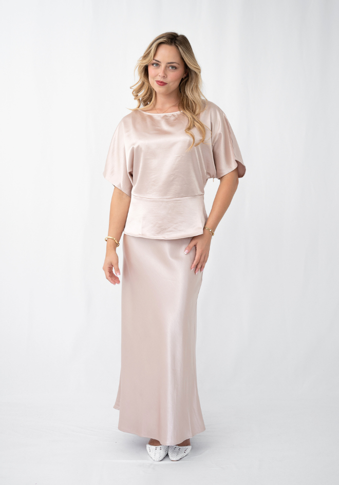 Woman wearing a satin outfit on a white background