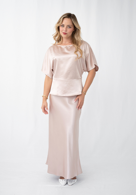 Woman wearing a satin outfit on a white background