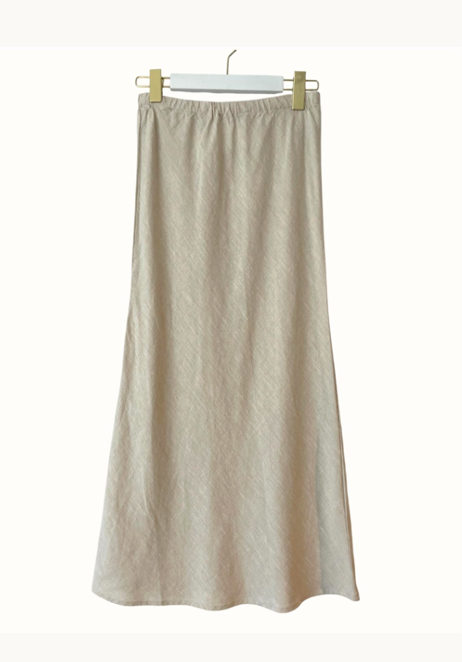 Beige skirt hanging on a white background