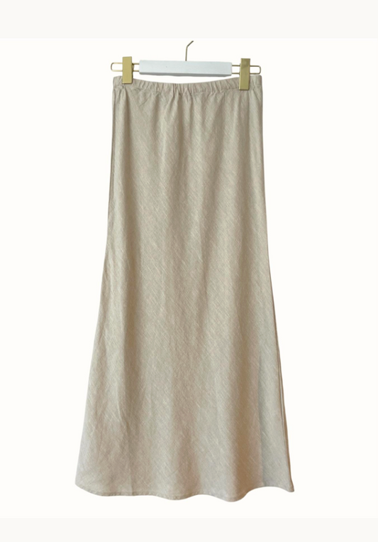 Beige skirt hanging on a white background