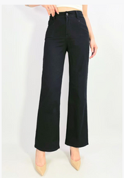 Black wide-leg jeans worn by a person on a white background
