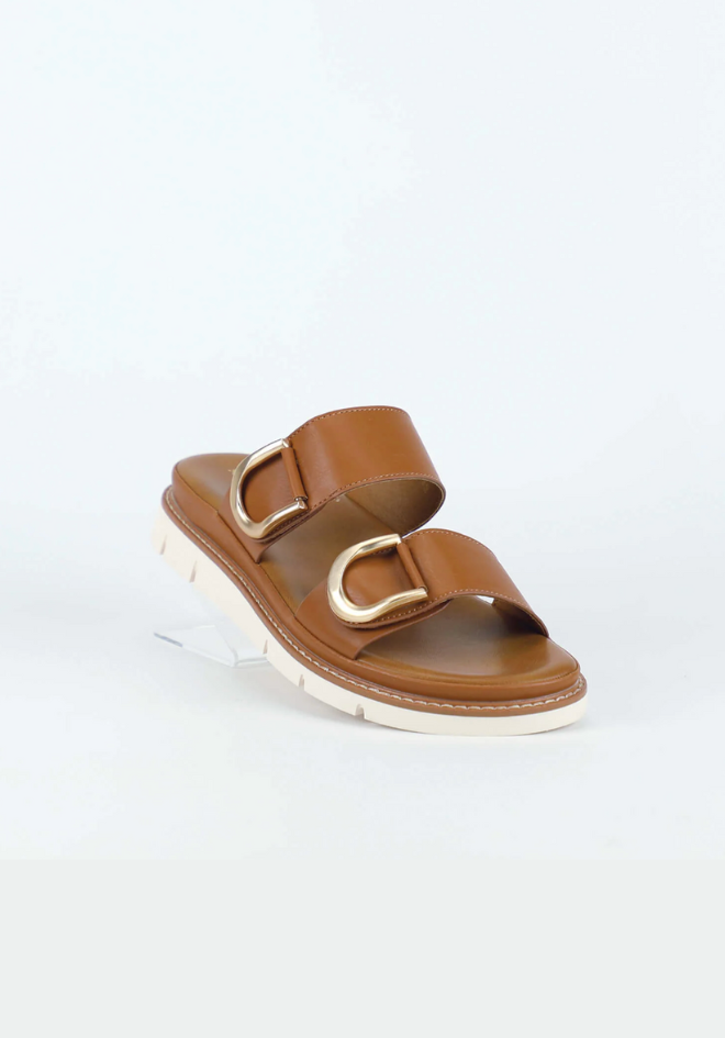 Brown sandal with gold accents on a light gray background