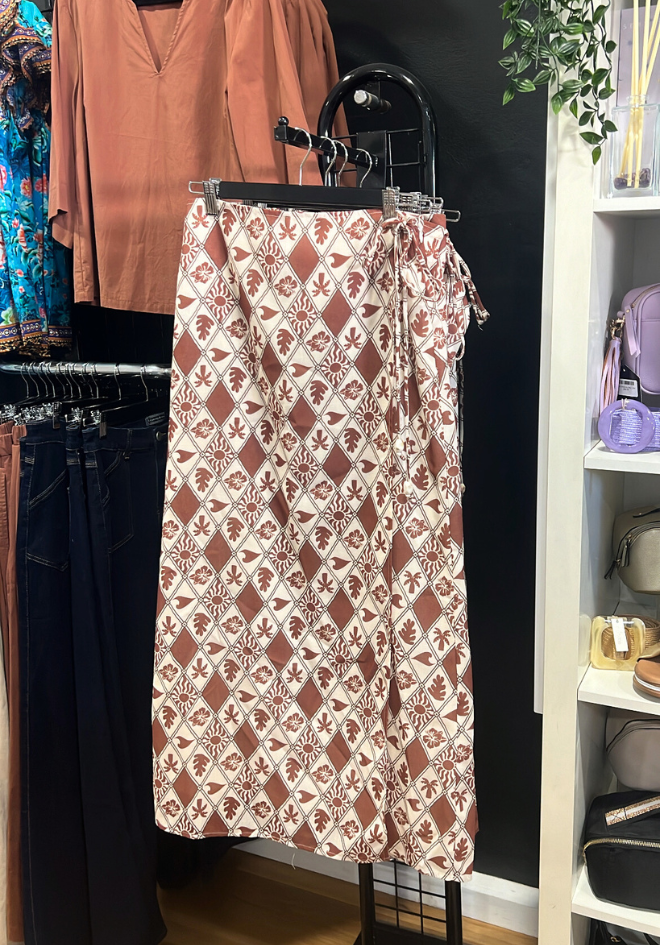 Patterned skirt on a rack with clothing in the background