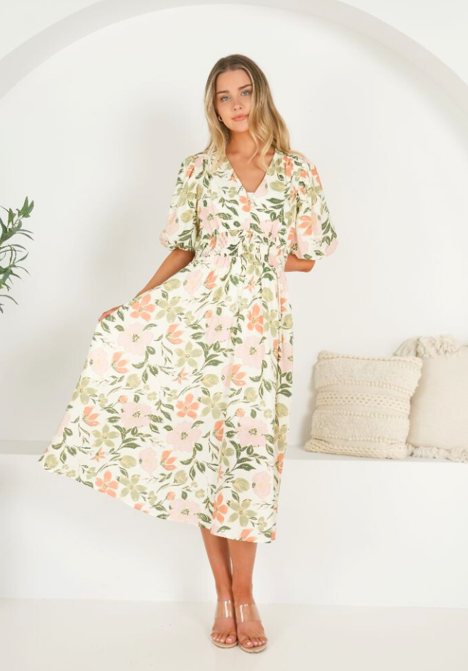 Woman wearing a floral dress in a minimalistic setting