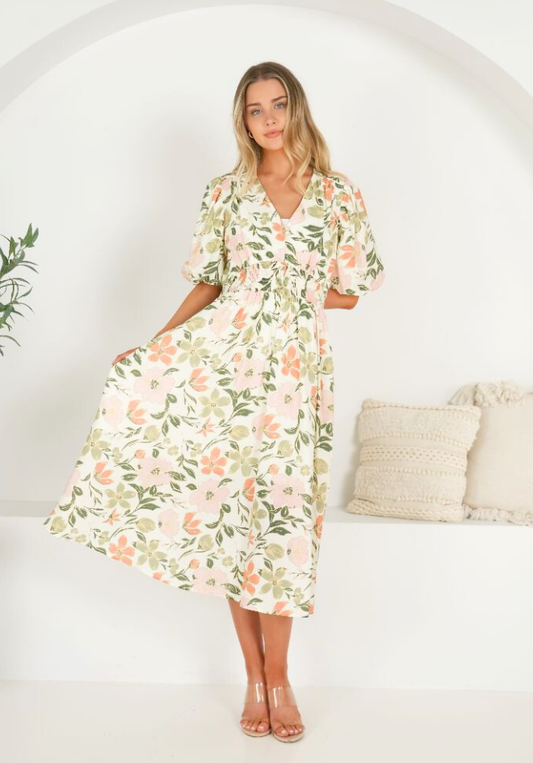 Woman wearing a floral dress in a minimalistic setting