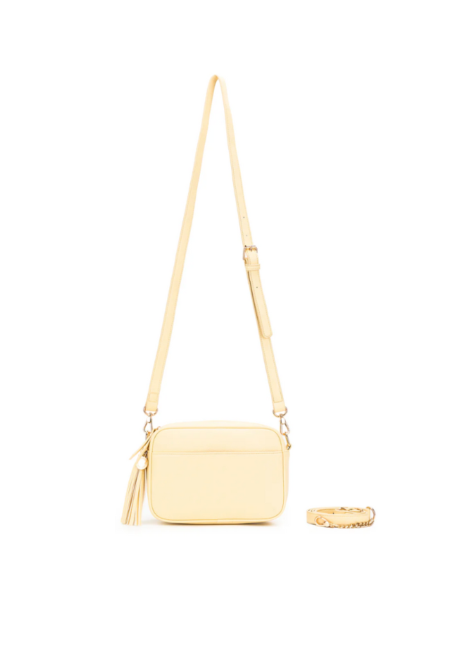 Yellow crossbody bag with a tassel on a white background