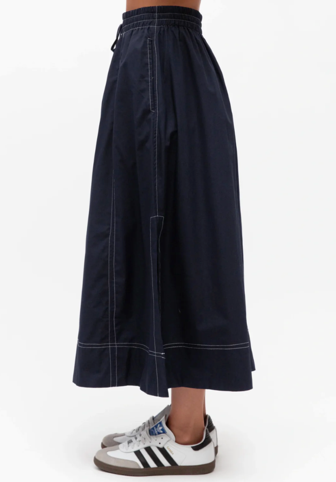 Label of Love Bella Midi Skirt Navy — close-up side view showing side split, pocket and white contrast stitching detail